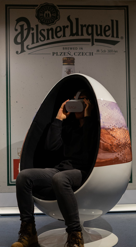A visitor watching SagaVR in an egg chair, RIFF XR 2021. Photo by Dia Istanbuly / RIFF